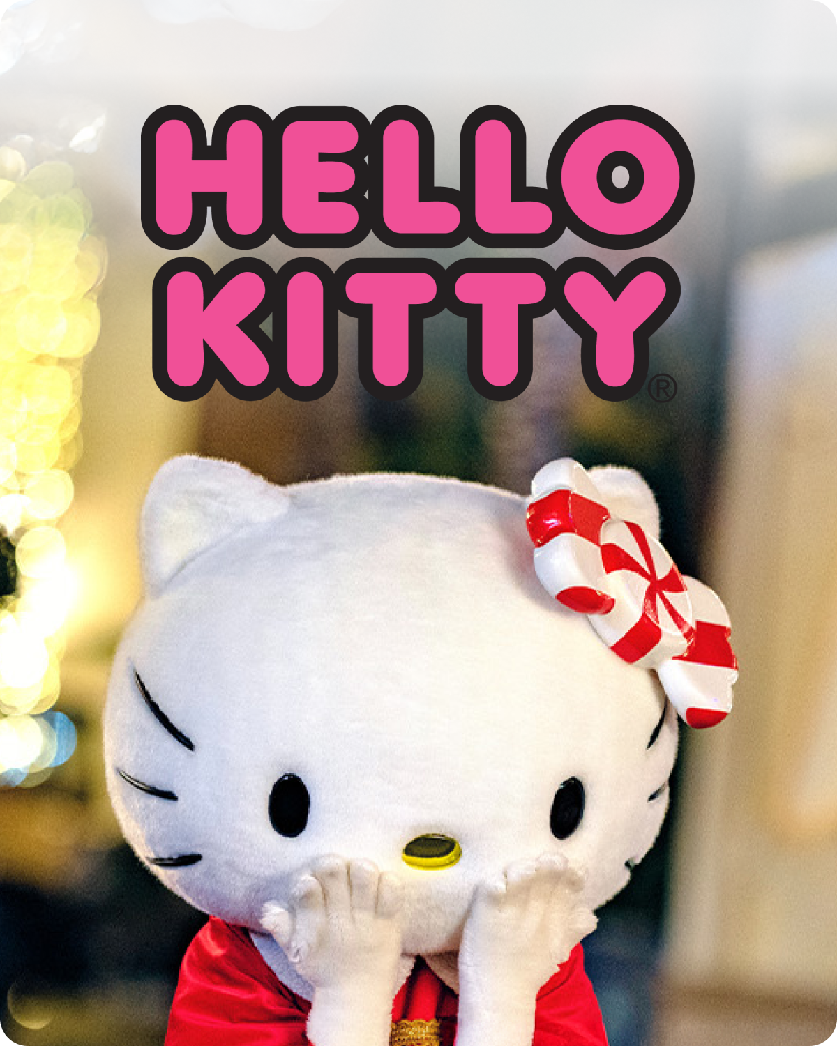 Hello Kitty plush toy with a candy cane hat on a blurred background - click to shop Hello Kitty merch now!