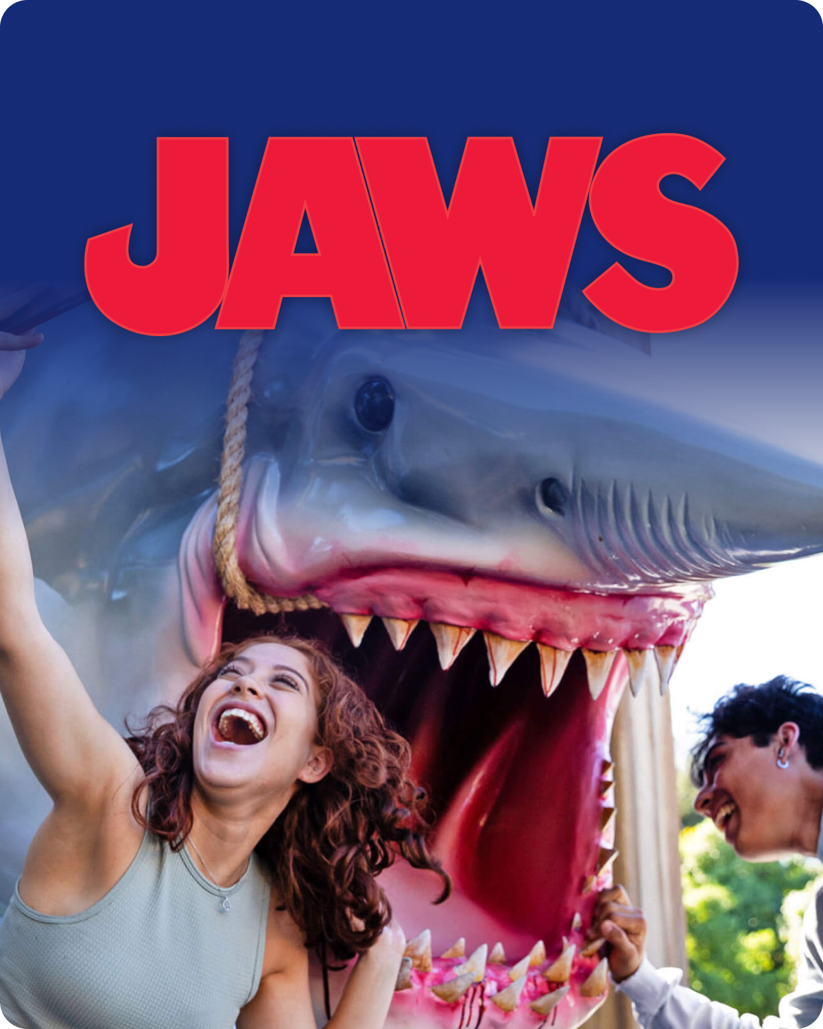 Image for 'Jaws' with a shark and two people in front of it - click to shop Jaws merch now!